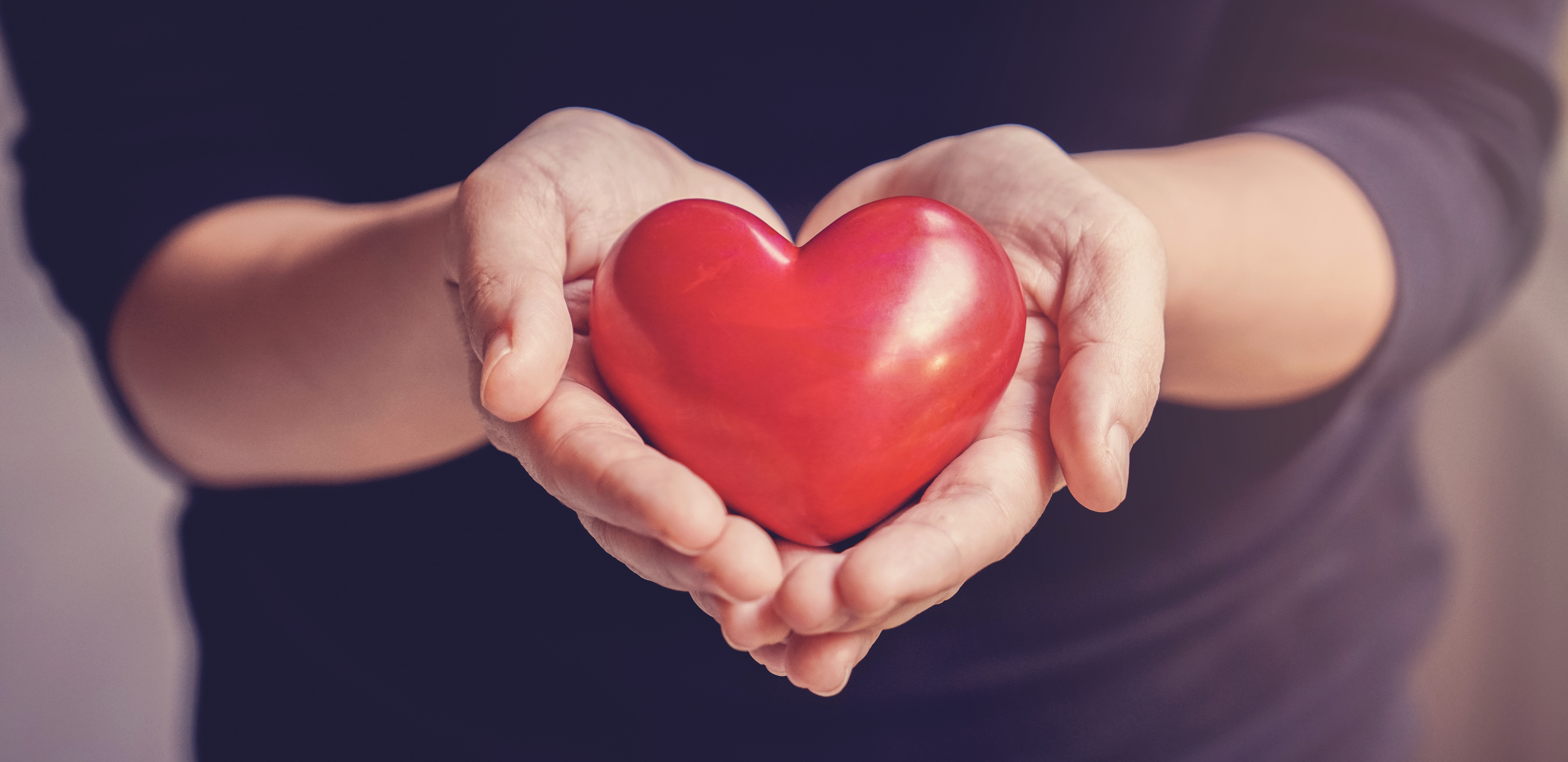 Woman holding red heart, health insurance, donation, happy charity volunteer concept, world mental health day, world heart day
